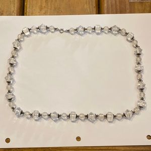 Acrylic faceted clear beads with silver color spacers strung on string c clasp